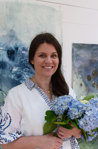 photo of Meghean Warner with blue hydrangeas in hand