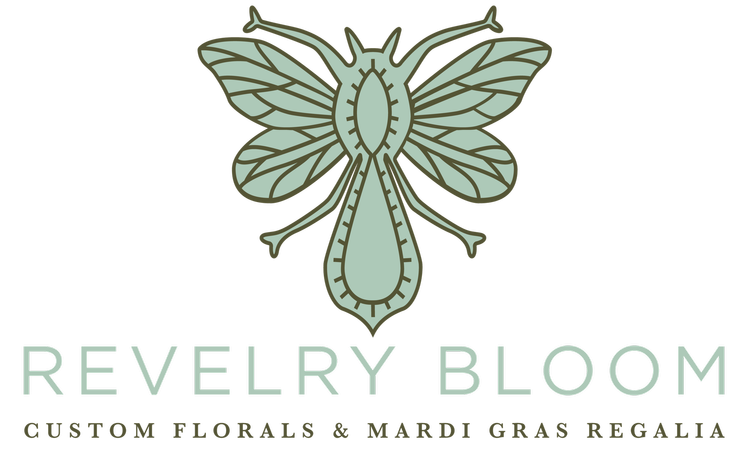 A mint green stylized floral insect or butterfly illustration above the text 'REVELRY BLOOM' and 'CUSTOM FLORALS & MARDI GRAS REGALIA' on a white background.