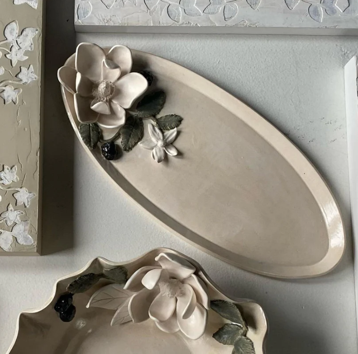 ceramic platter with ceramic magnolia arrangement on side by Saron Henderson