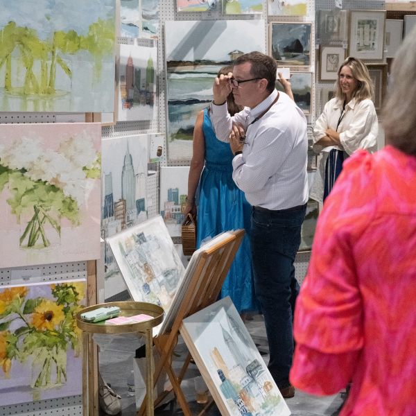 guests looking at work at the loyola art show