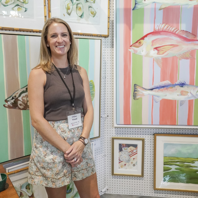 photo of chloe wood at her booth in the 2024 loyola art show