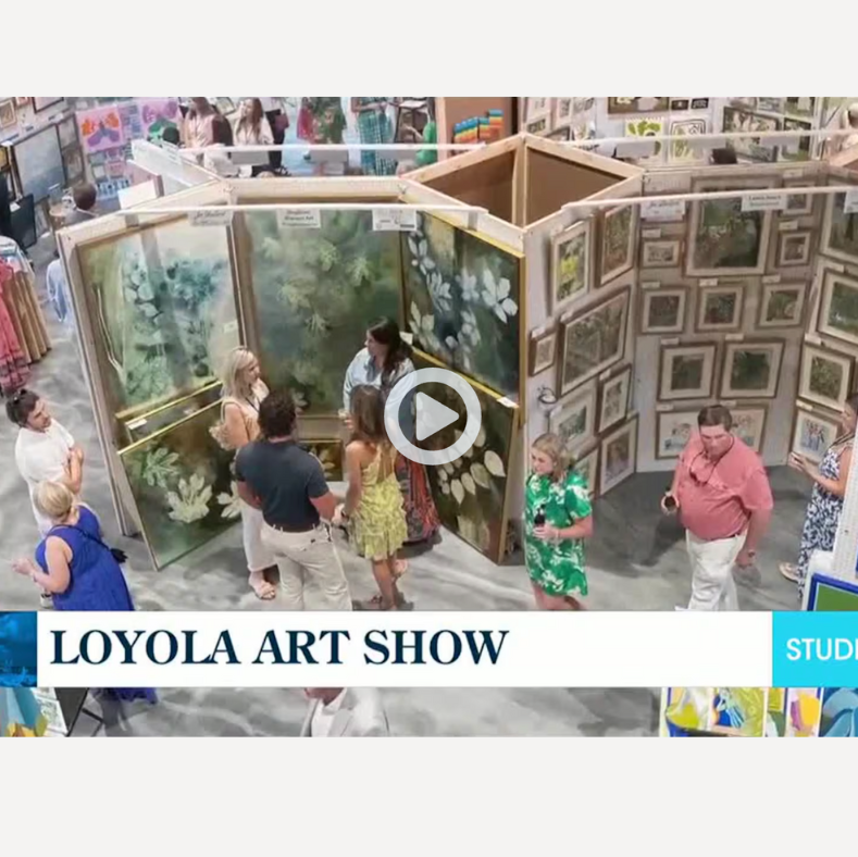 People visiting an art show with various artworks displayed.